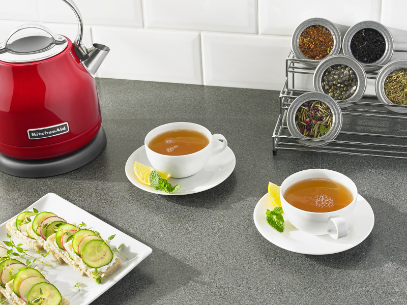 Two cups of tea on saucers with lemon and mint Two cups of tea on saucers with lemon and mint