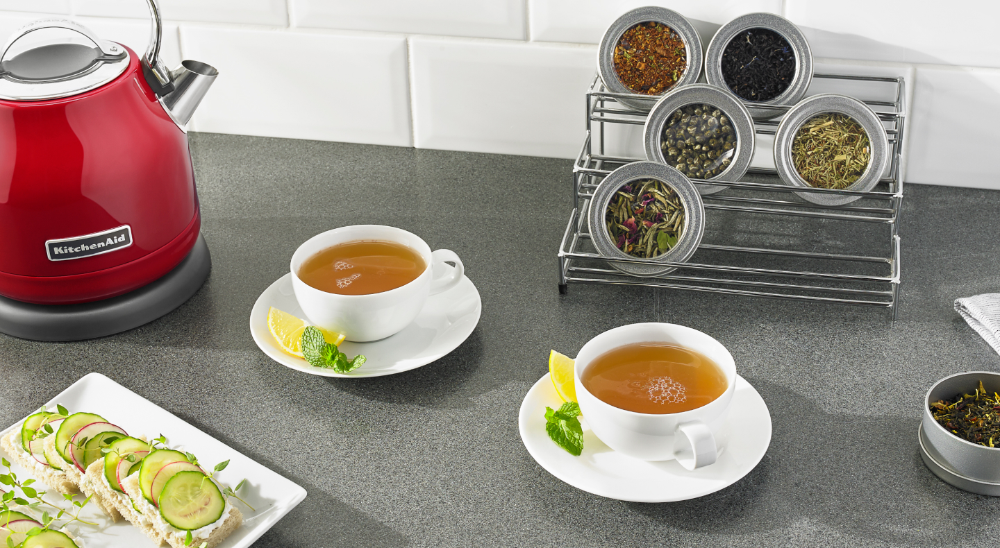 Two cups of tea on saucers with lemon and mint Two cups of tea on saucers with lemon and mint