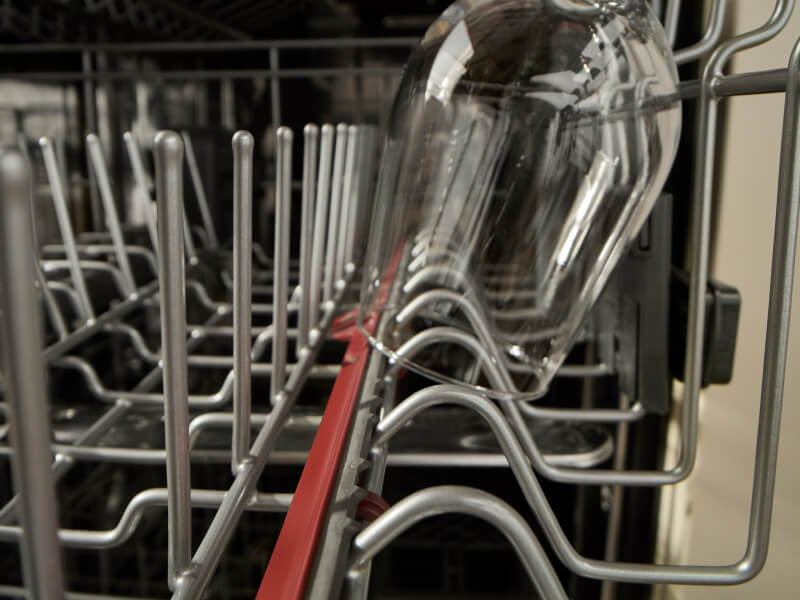 Close-up of wine glass in a KitchenAid® dishwasher rack
