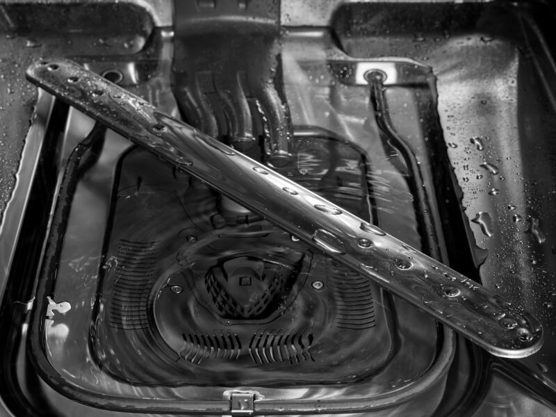 Closeup of spray arm at the base of the dishwasher
