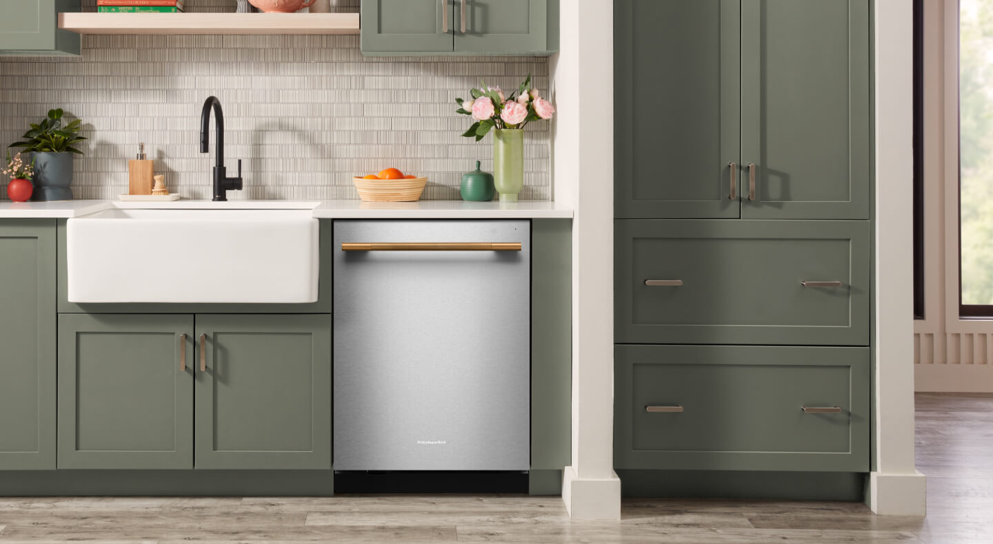 Stainless steel KitchenAid® dishwasher with a bronze handle