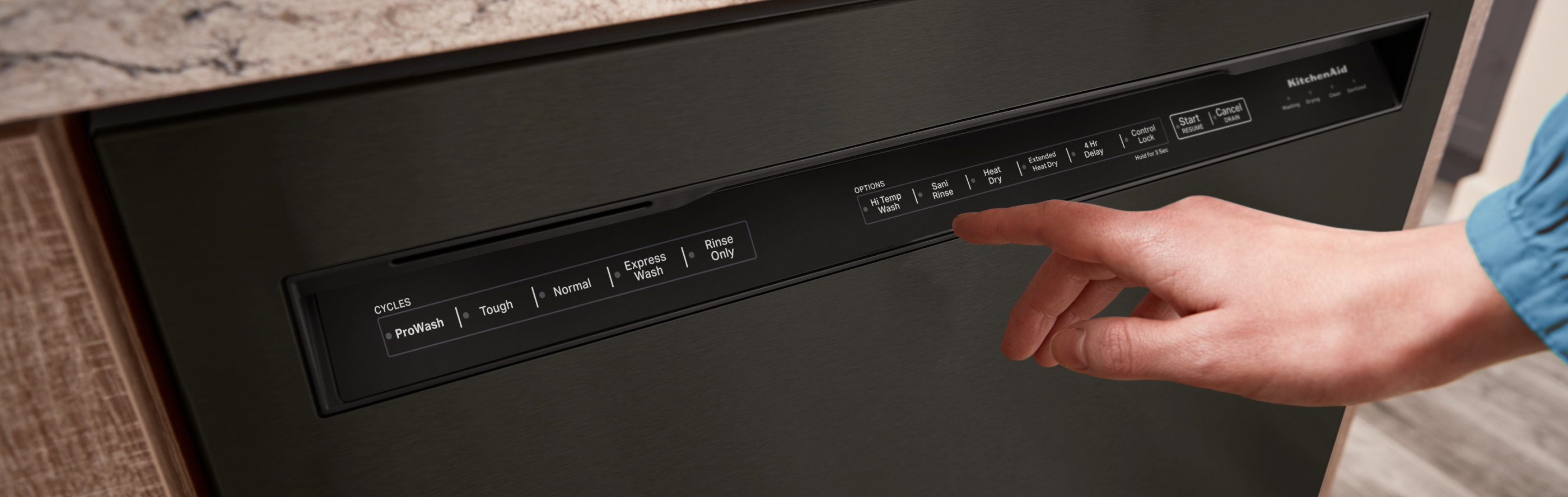 Person selecting settings on a KitchenAid® dishwasher