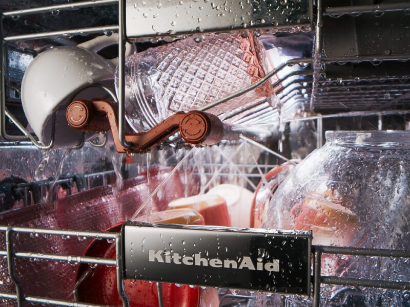 Dishes being washed inside a dishwasher
