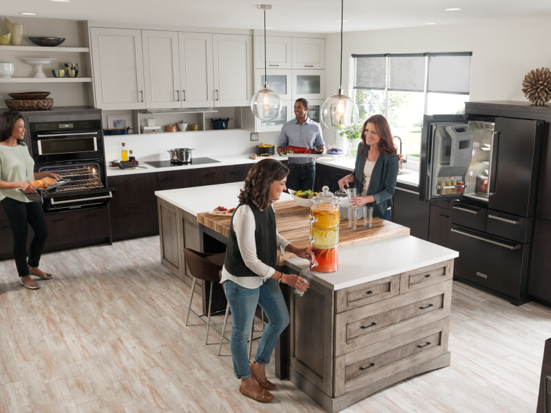 People gathering and cooking in an open concept kitchen