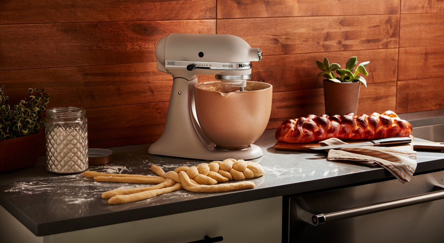 KitchenAid® stand mixer with freshly baked bread on the counter. KitchenAid® stand mixer with freshly baked bread on the counter.