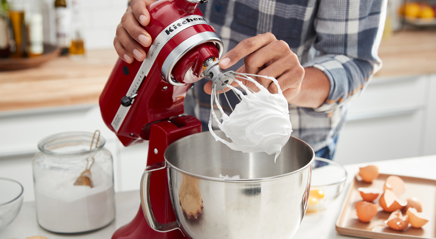 Red KitchenAid® stand mixer making homemade meringue Red KitchenAid® stand mixer making homemade meringue