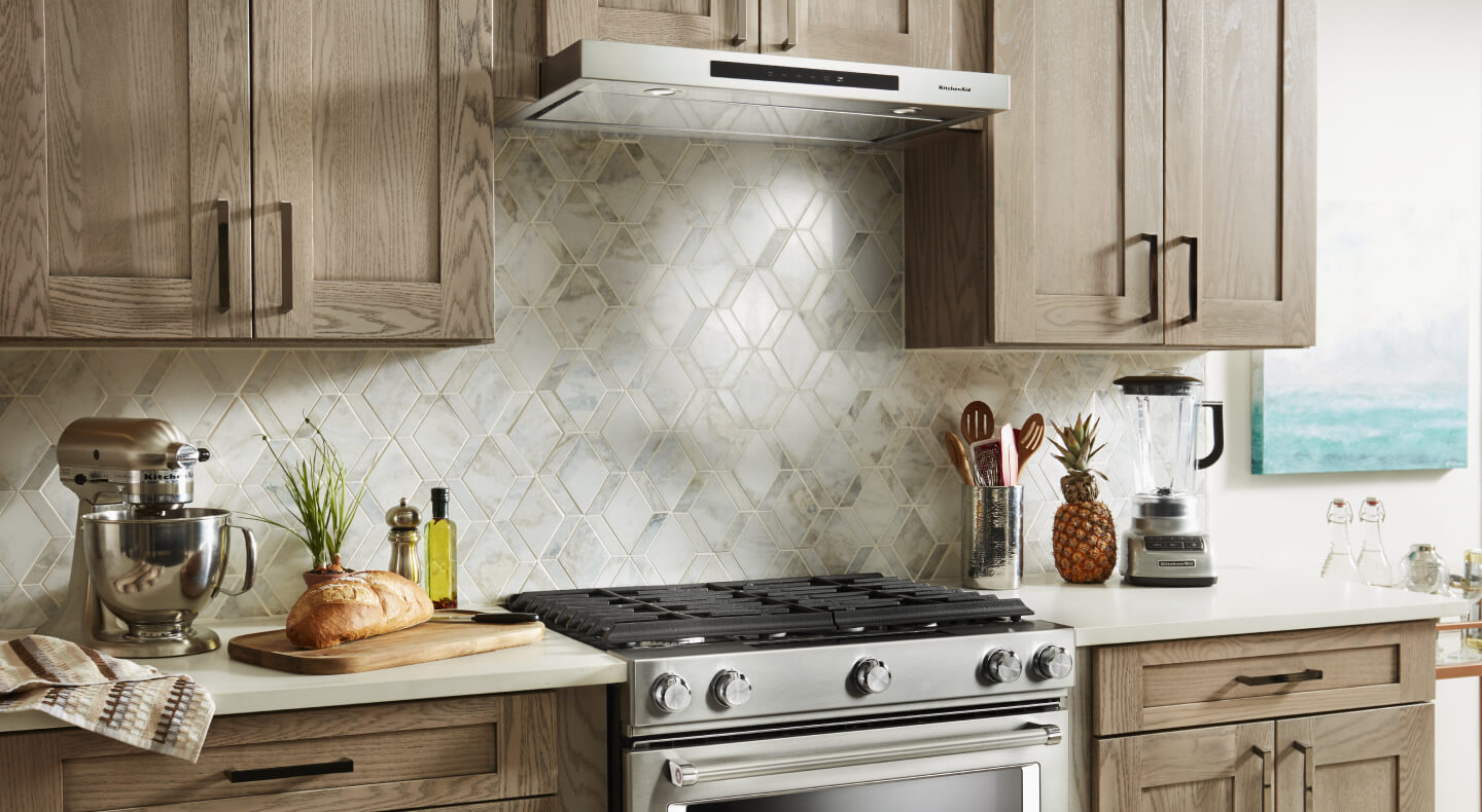 Gas range and an under-cabinet hood in a modern kitchen