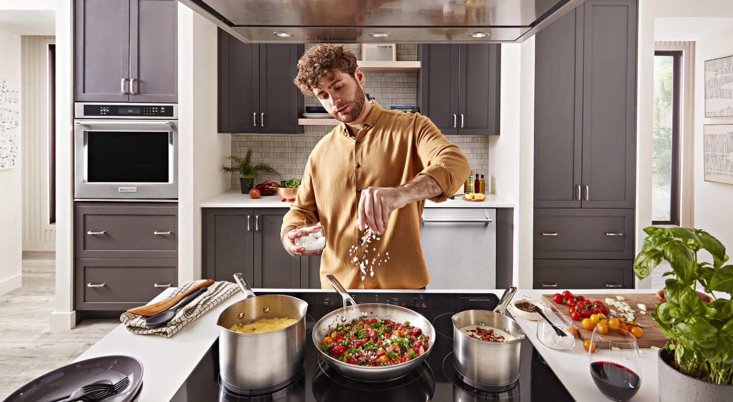 Person cooking on an electric cooktop