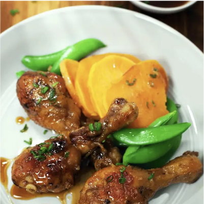 A plate of roasted chicken legs with spicy maple glaze