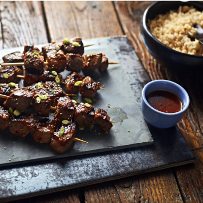 Meat with hot sauce on a cutting board