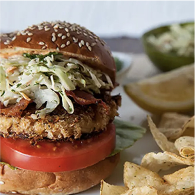 A king crab BLT sandwich with potato chips