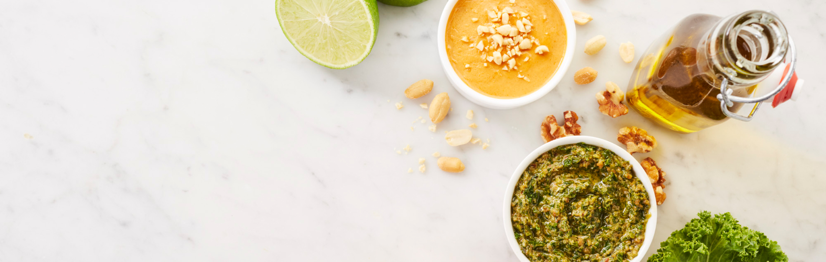 Several sauces and ingredients resting on a marble countertop