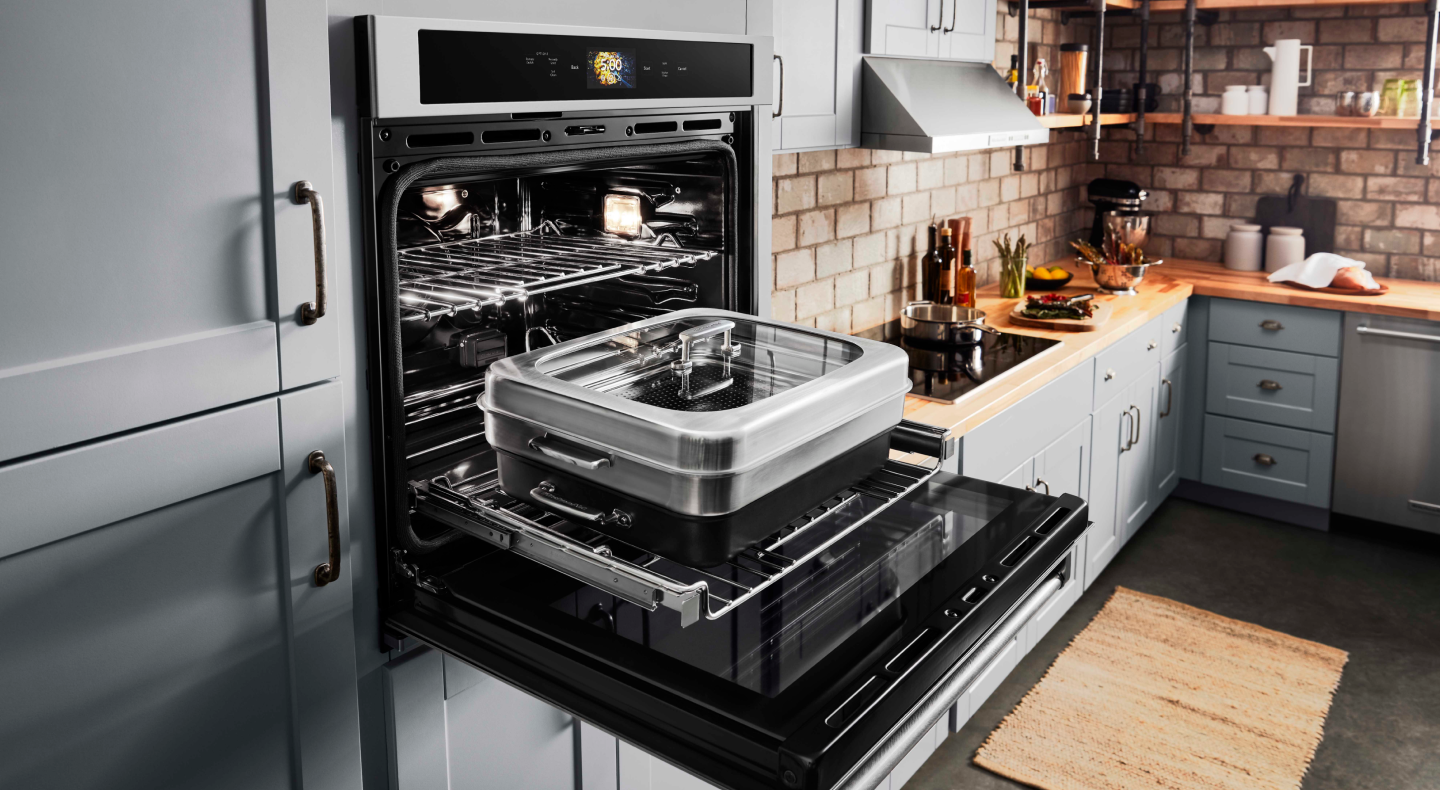 An open smart wall oven with attachment