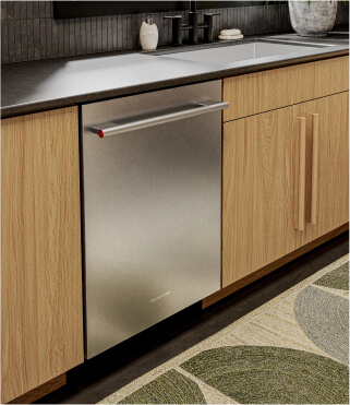 A KitchenAid® dishwasher surrounded by light brown cabinets