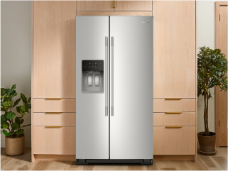 A KitchenAid® refrigerator surrounded by brown cabinetry