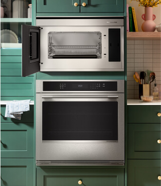 A KitchenAid® wall oven surrounded by teal cabinetry