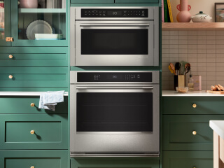 A KitchenAid® wall oven surrounded by green cabinetry