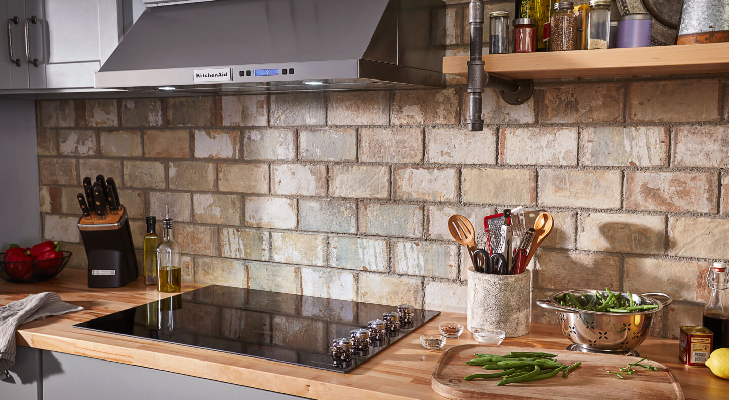 A kitchen with a glass cooktop and wooden counters