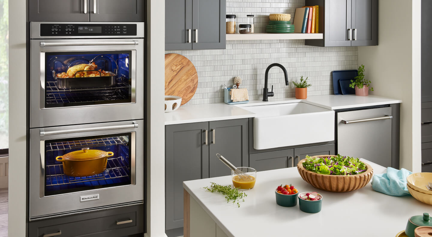 A kitchen with a KitchenAid® double wall oven and a stainless steel dishwasher