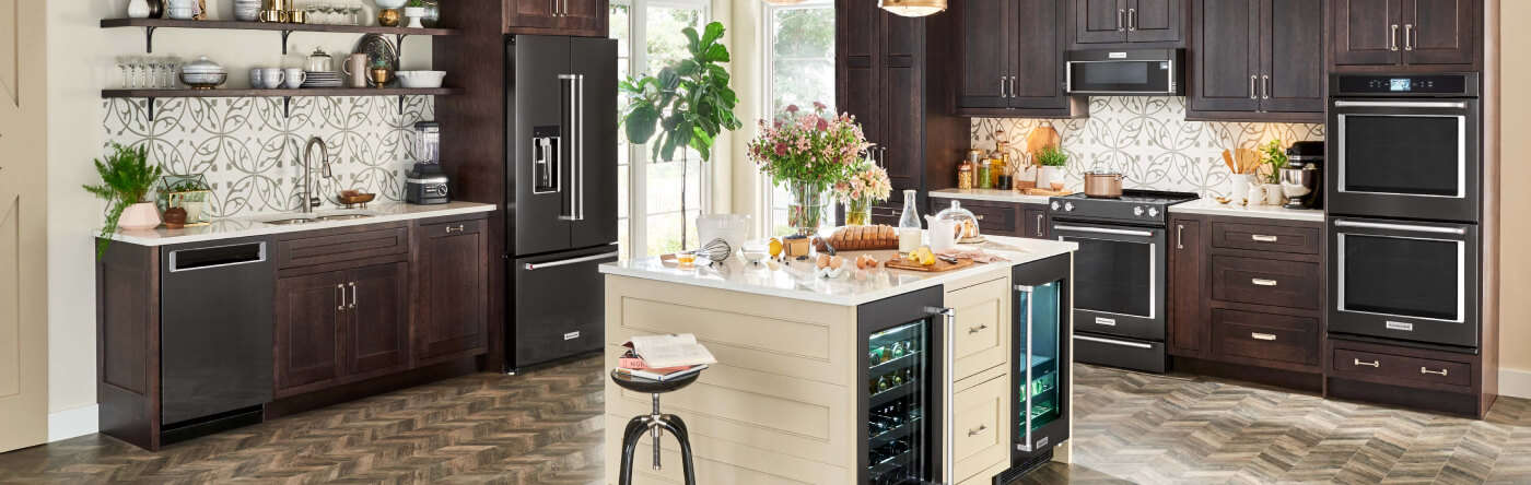 A large kitchen with an island and dark appliances
