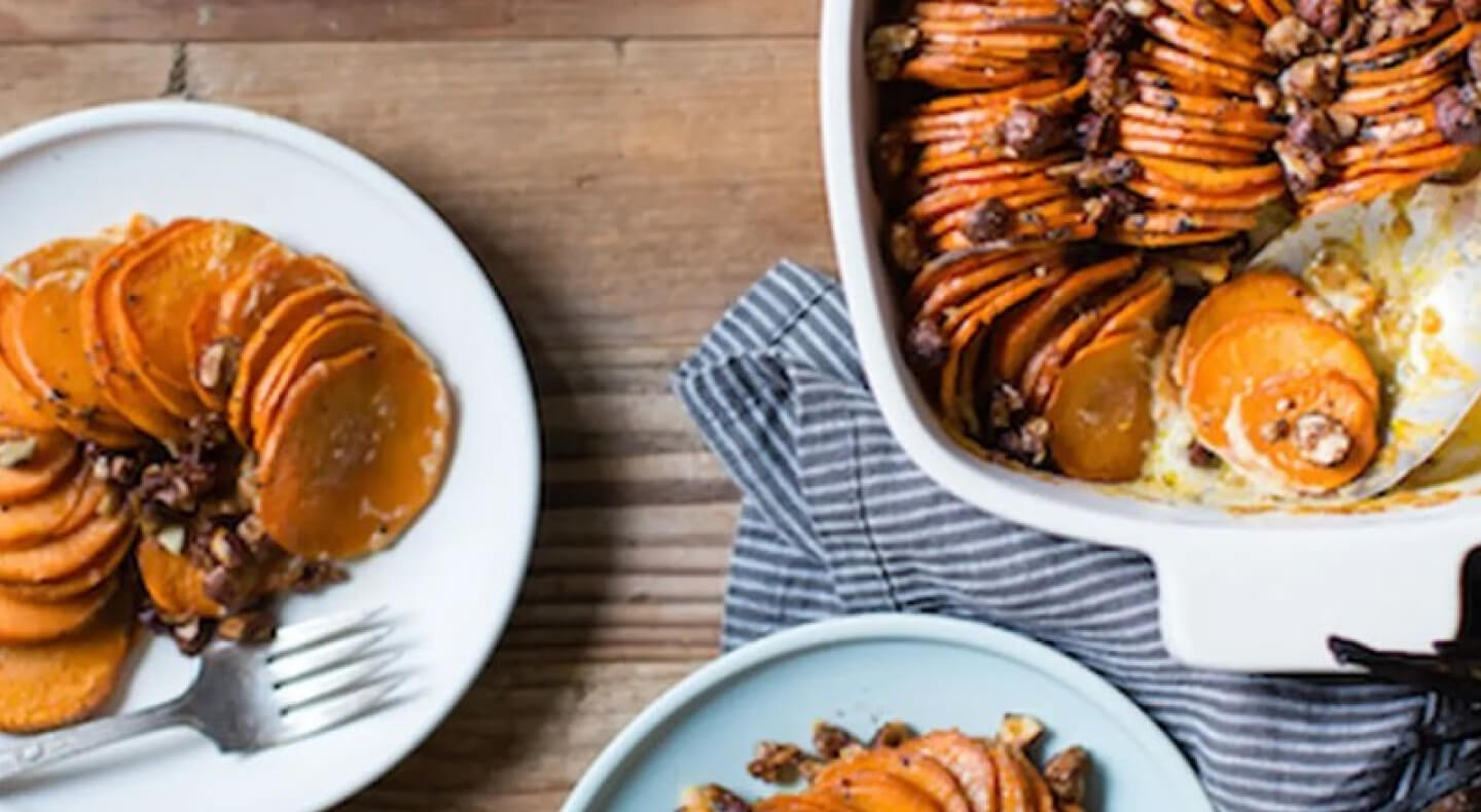 Birds-eye view of thinly sliced sweet potatoes in au gratin