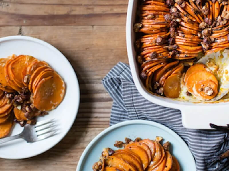 Birds-eye view of thinly sliced sweet potatoes in au gratin
