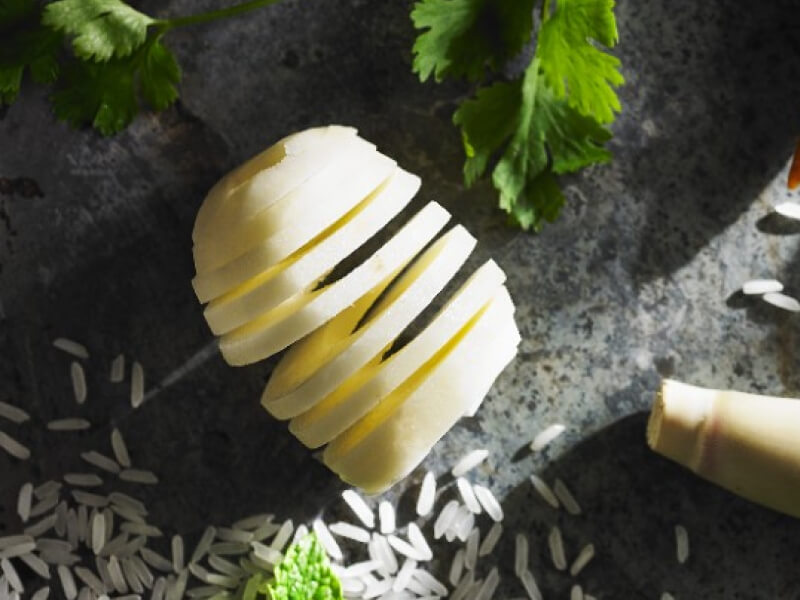 Spiral sliced potatoes on countertop with ingredients Spiral sliced potatoes on countertop with ingredients