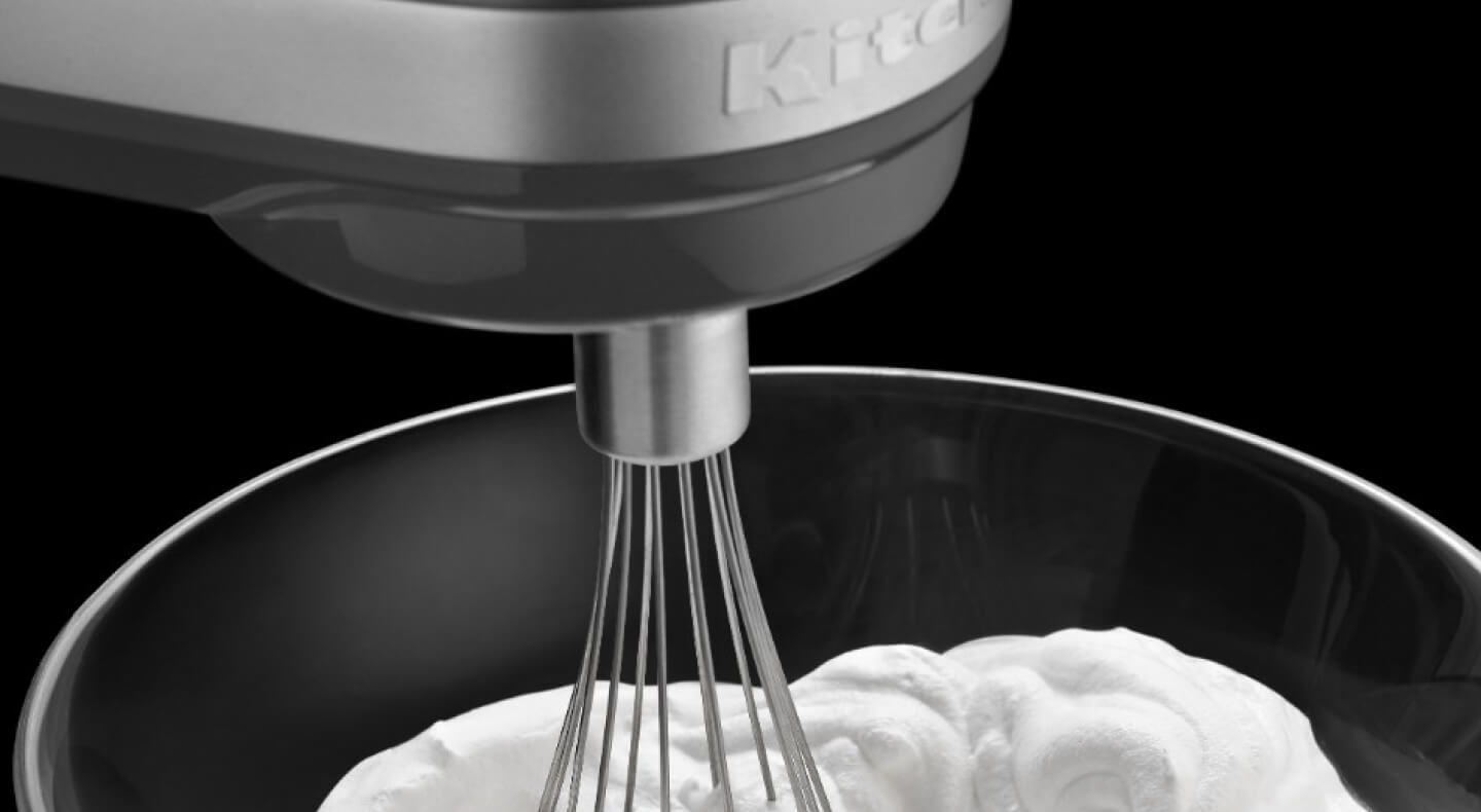 Close-up of cream being whipped with a KitchenAid® stand mixer