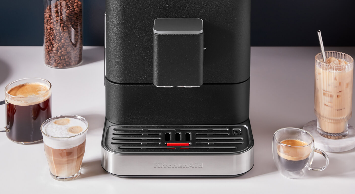 Espresso beverages around a black KitchenAid® Fully Automatic Espresso Machine 