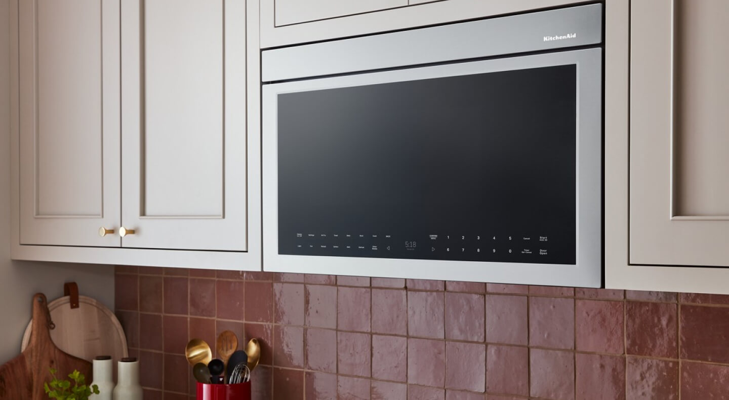 A KitchenAid® microwave above a stovetop