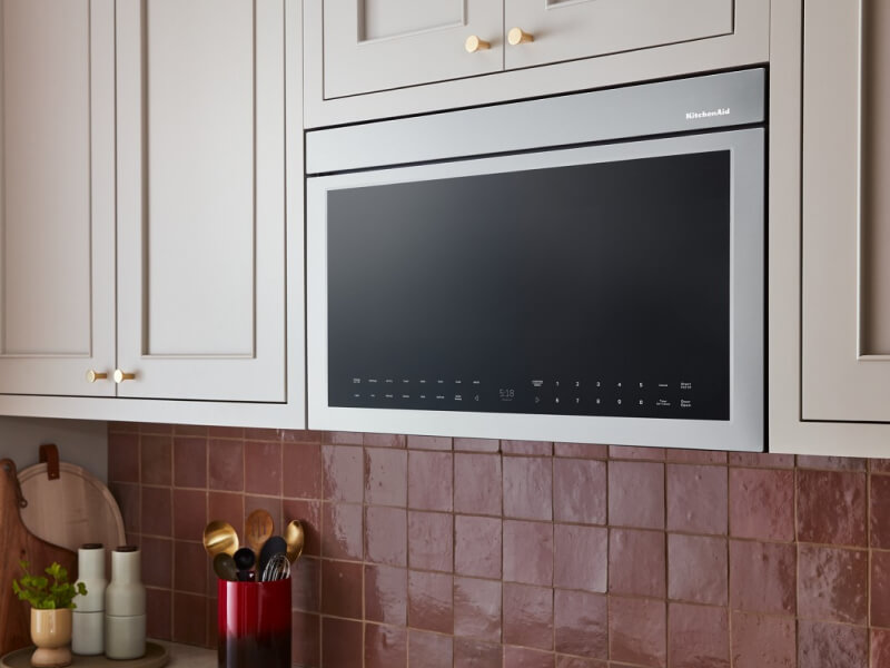 A KitchenAid® microwave above a stovetop