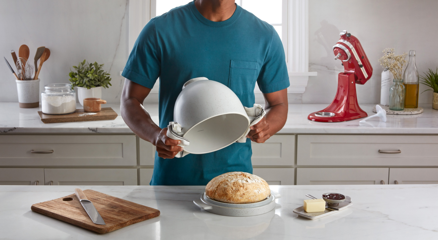 Person removing the KitchenAid® bread bowl off of a loaf of bread Person removing the KitchenAid® bread bowl off of a loaf of bread