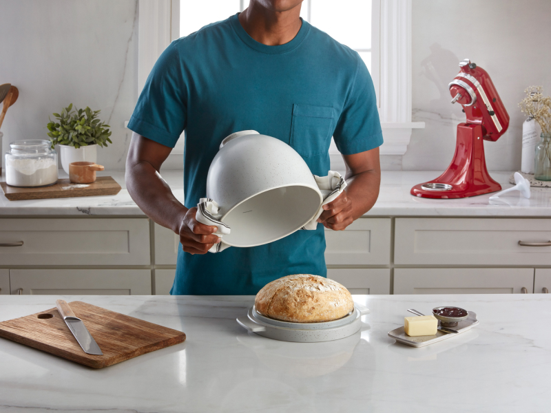 Person removing the KitchenAid® bread bowl off of a loaf of bread