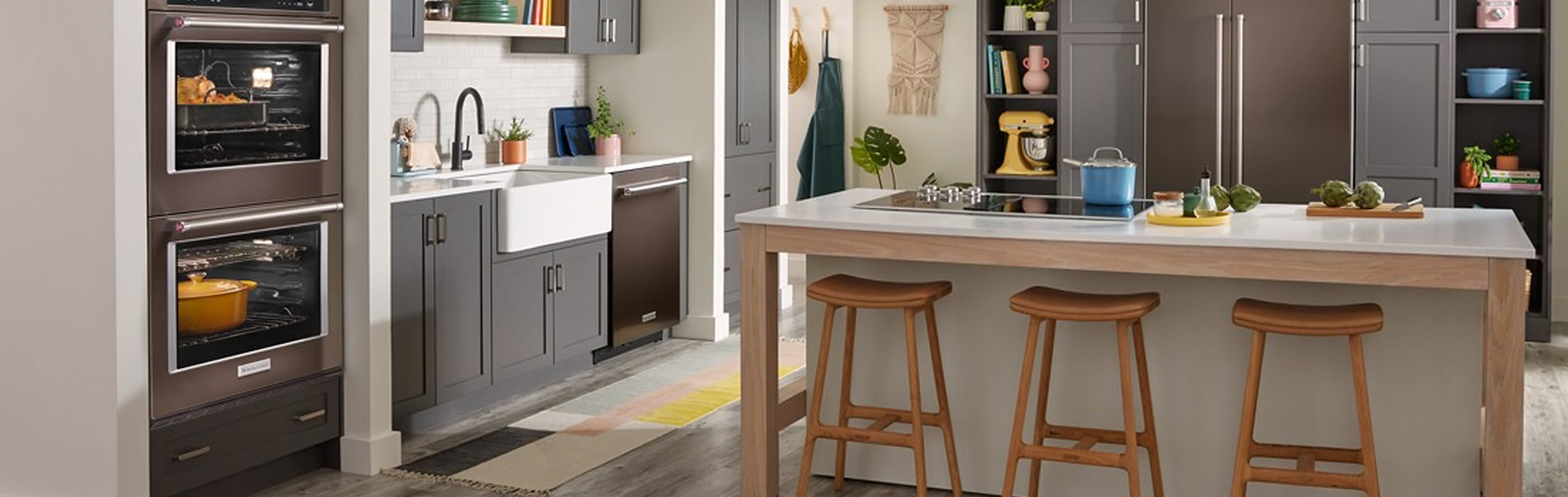 A KitchenAid® wall oven with a Dutch oven and whole chicken roasting inside