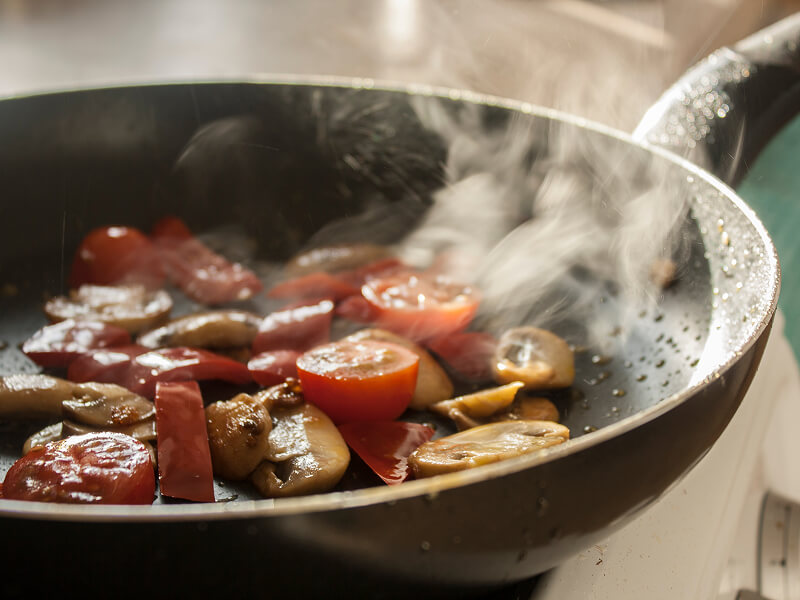Chopped food frying in a frying pan