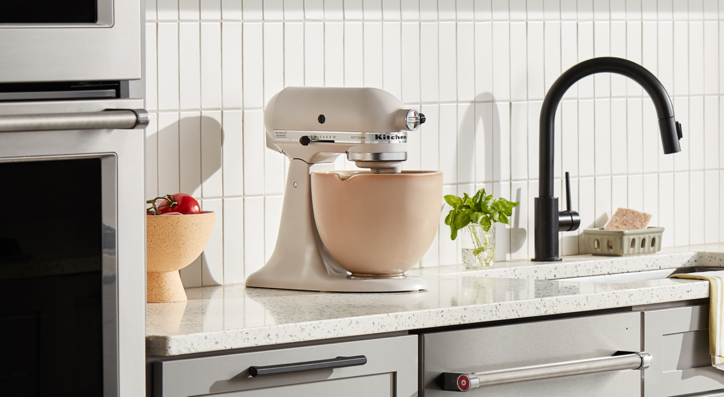 Cream KitchenAid® stand mixer with a beige mixing bowl  Cream KitchenAid® stand mixer with a beige mixing bowl