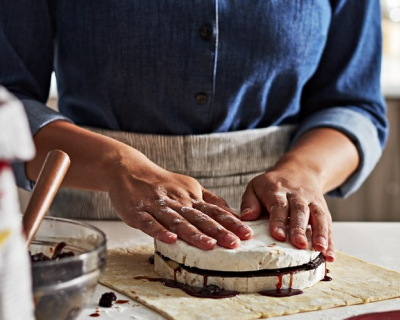 Person making a pastry on a countertop