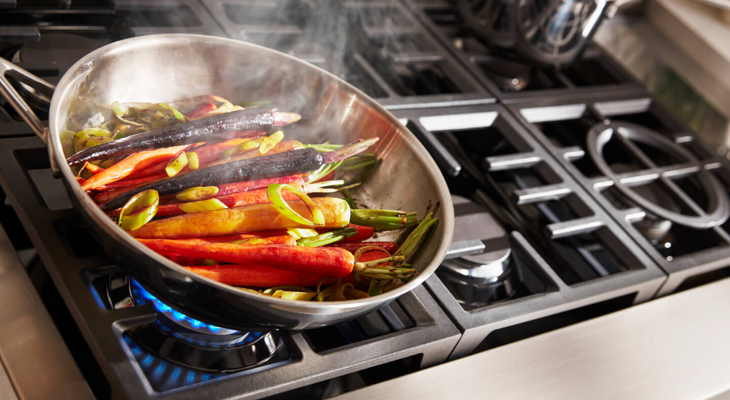 Carrots cooking in a pan on a cooktop
