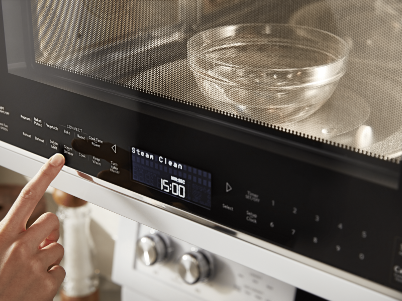 Person selecting a cook option on a KitchenAid® microwave