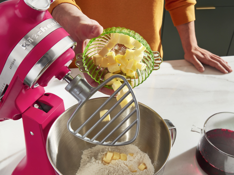 Person adding butter into a KitchenAid® stand mixer Person adding butter into a KitchenAid® stand mixer