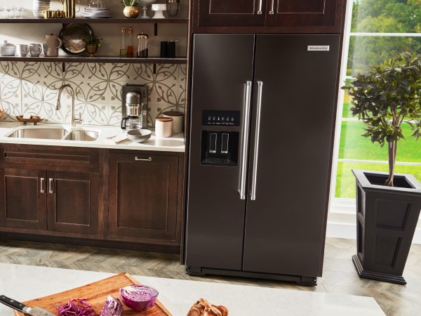 KitchenAid® side-by-side refrigerator in brown cabinetry