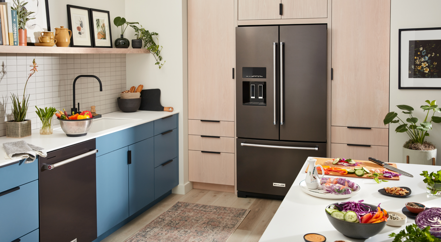 KitchenAid® French-door refrigerator with ice dispenser built into light brown cabinetry KitchenAid® French-door refrigerator with ice dispenser built into light brown cabinetry