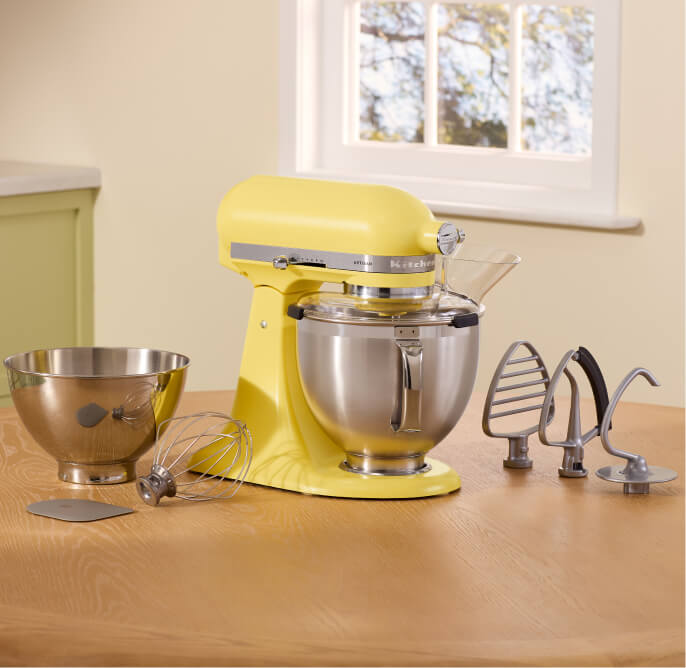 The Butter stand mixer alongside various beaters, bowls and dough hooks.