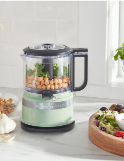 An Evergreen stand mixer sitting on a countertop.