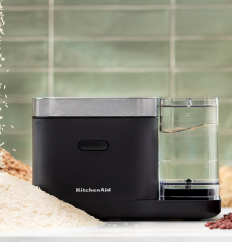 A KitchenAid Grain and Rice Cooker against a green tile backsplash