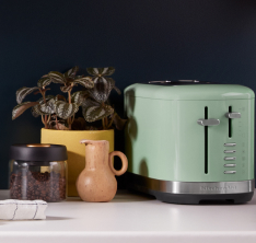 A KitchenAid 2 Slice Toaster against a black backsplash