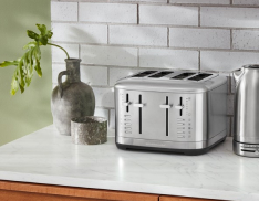 A KitchenAid 4 Slice Toaster on a white countertop against a subway tile backsplash