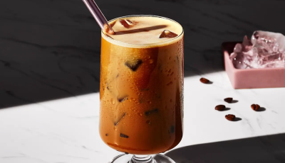 Iced espresso in a glass with a straw