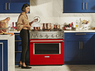 Person in front of a red kitchen range