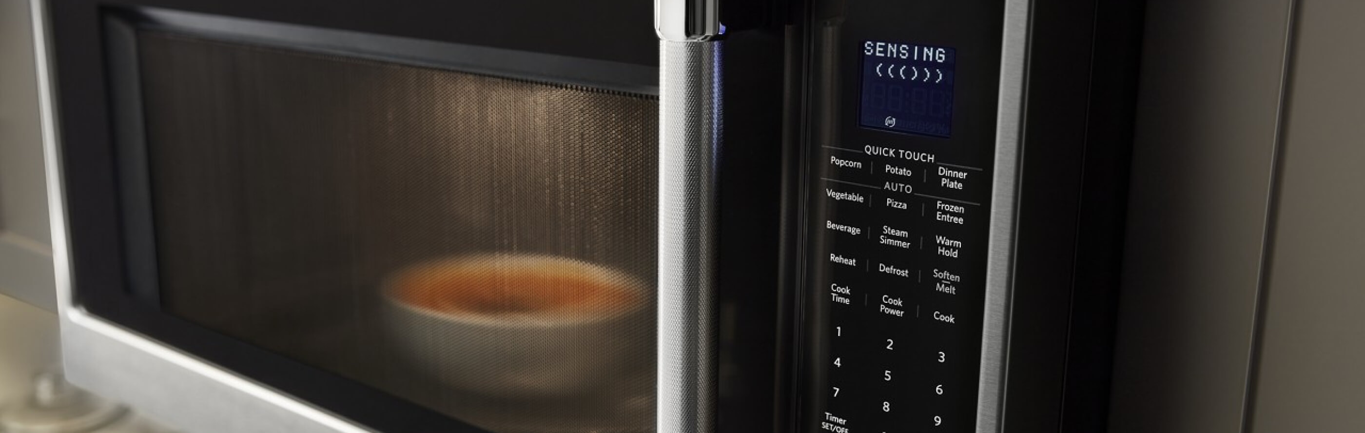 Food cooking in the microwave with SENSING shown on the display